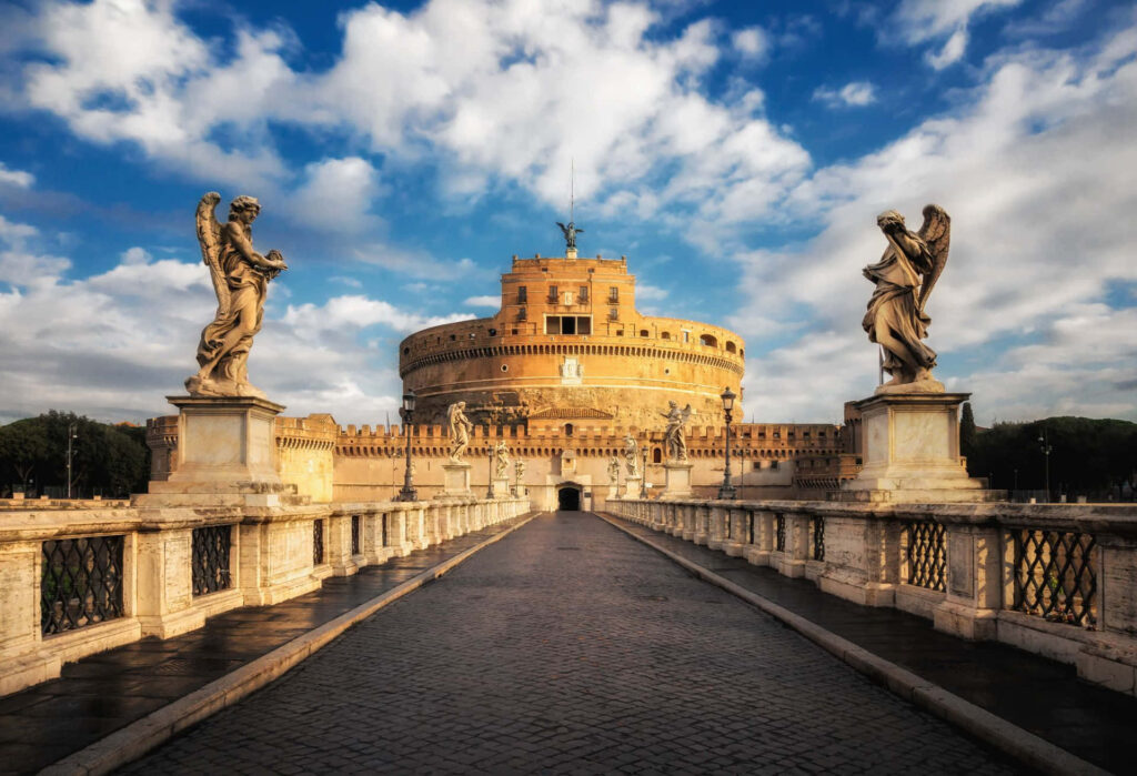 Castel Sant Angelo in Rome with angel statues under vibrant blue sky and scattered clouds HD wallpaper