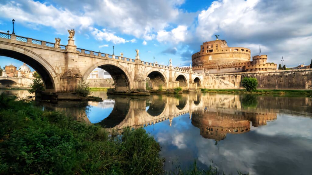 Castel Sant Angelo Rome fortress reflected in calm Tiber River with dramatic sky and ancient bridge Wallpaper