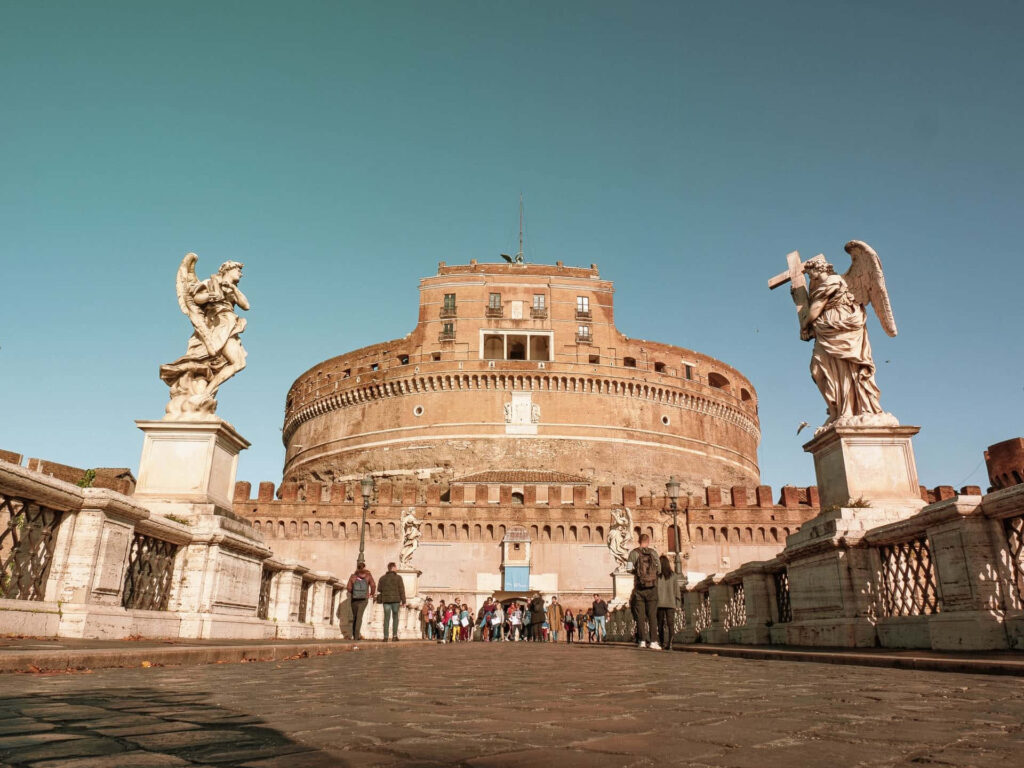 Castel Sant Angelo Rome bathed in warm sunlight under clear blue sky historic fortress wallpaper