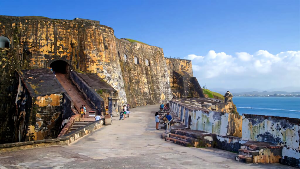 Historic Castillo San Felipe del Morro stone walls and ocean views under vibrant blue sky wallpaper