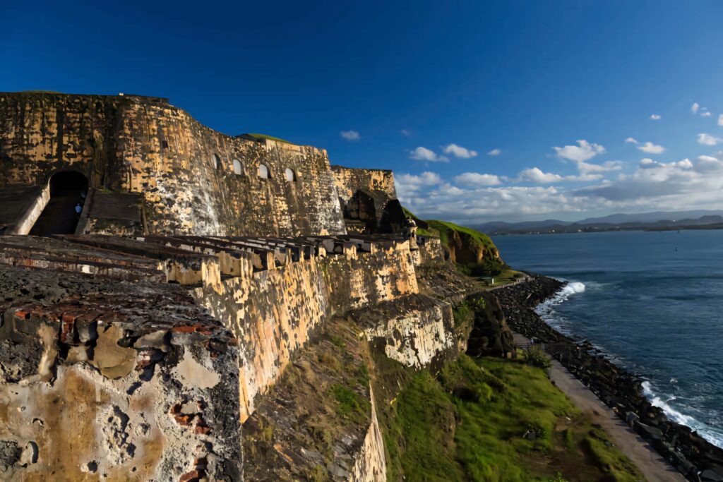 Castillo San Felipe del Morro fortress in Puerto Rico bathed in sunlight with ocean view wallpaper