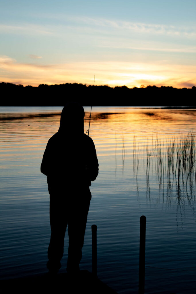 Tech-Savvy Fisherman: A Digital Catch in a Fishing Phone Backdrop Wallpaper
