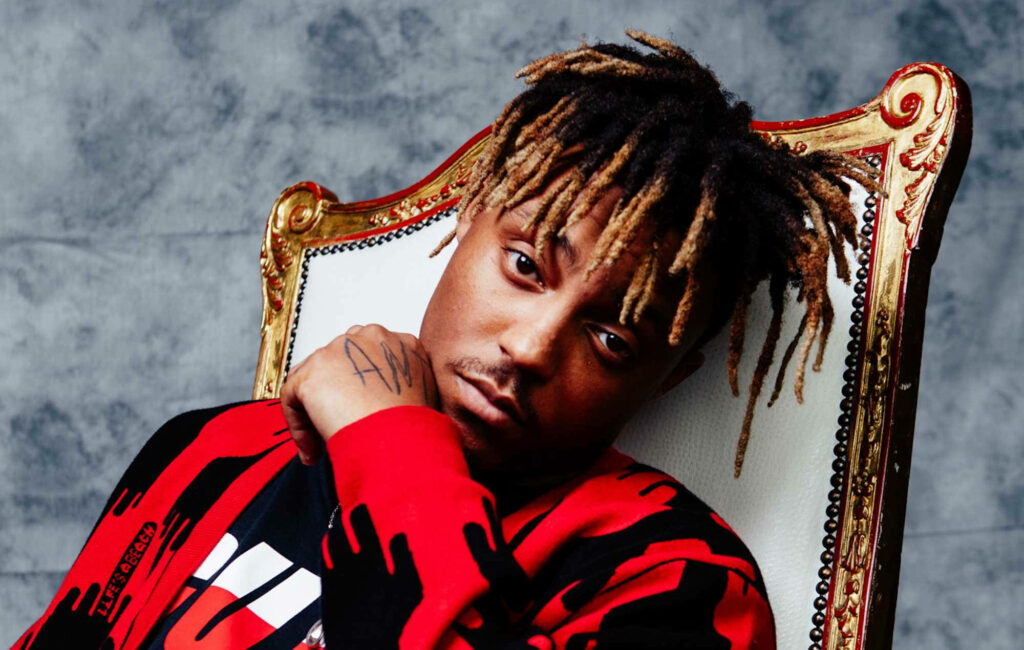 Red-Streaked Reflections of Juice Wrld: Captivating Background Featuring the Late Rapper Gazing into the Lens Wallpaper