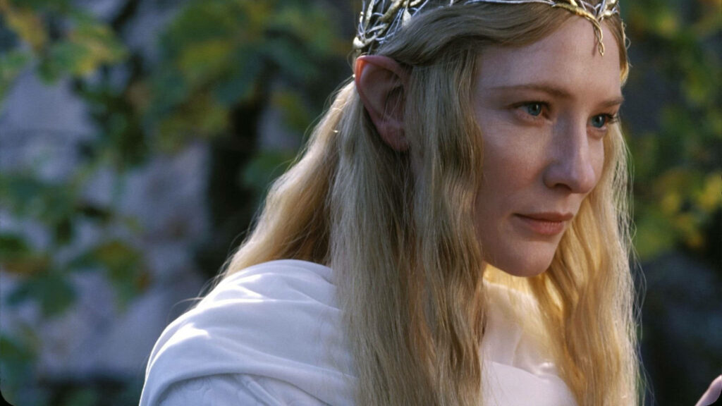 Cate Blanchett as Galadriel with flowing blonde hair and crown in serene mystical forest wallpaper