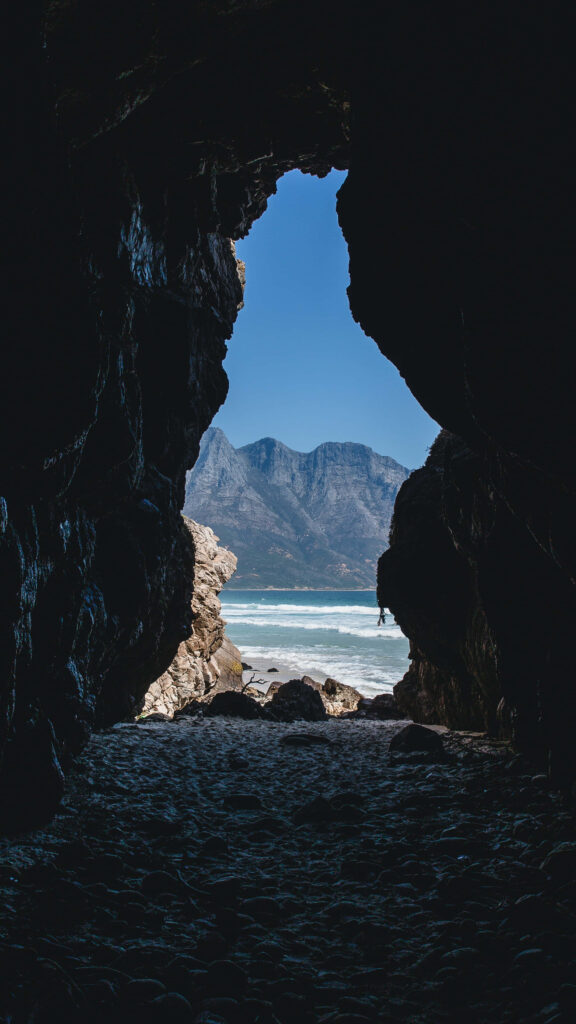 Cave View Wallpaper: Serene Beach & Majestic Mountains Contrast