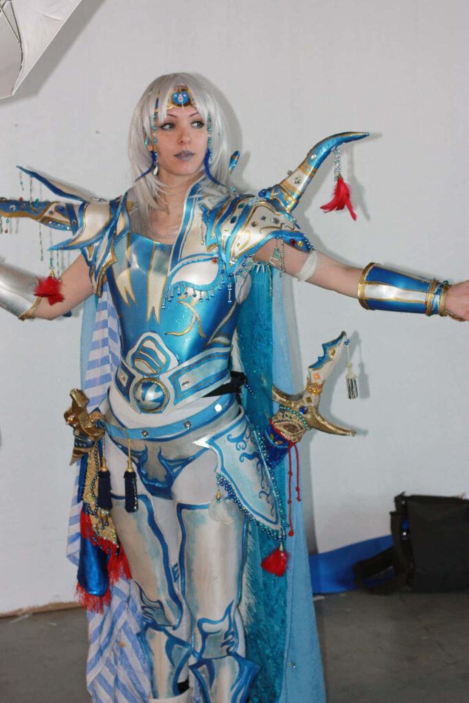 Cosplayer as Cecil Harvey Final Fantasy IV in detailed blue silver gold armor with flowing cape Wallpaper