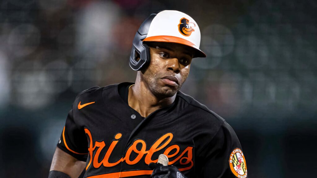 Cedric Mullins Baltimore Orioles in action focused dynamic energy blurred stadium background Wallpaper