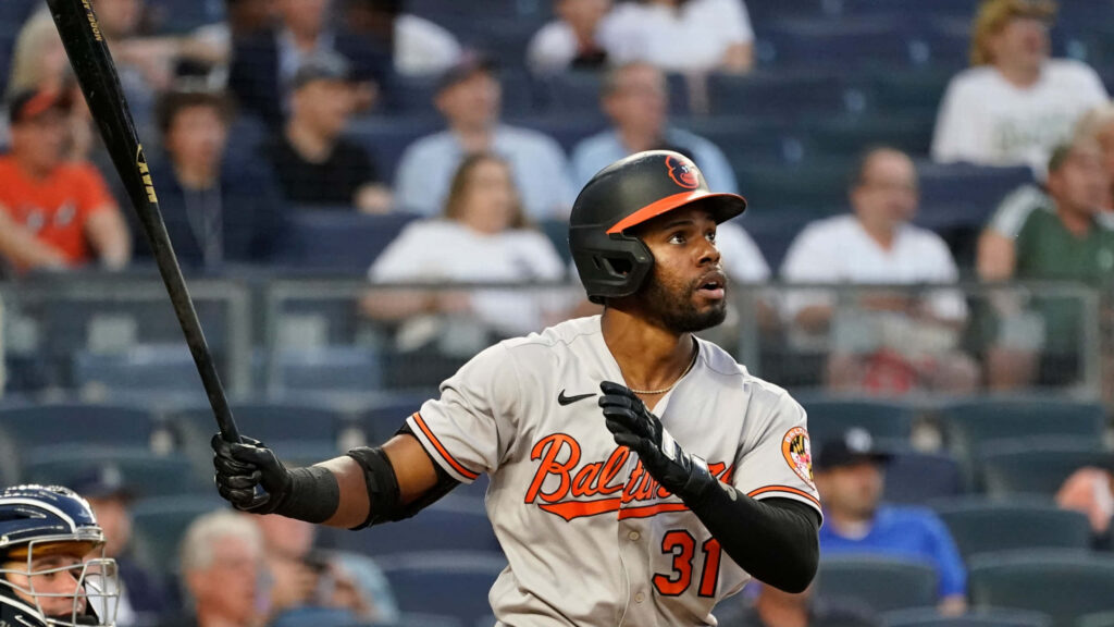 Cedric Mullins Baltimore Orioles mid swing at bat intense action MLB game stadium background Wallpaper