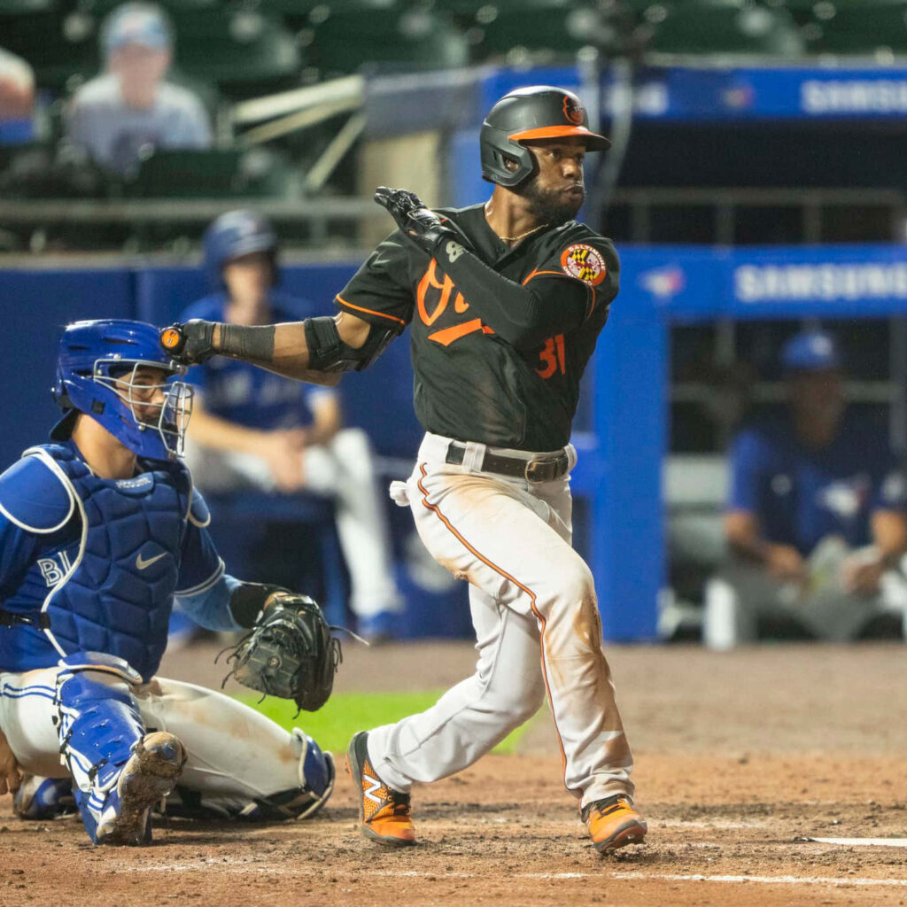 Cedric Mullins making a dynamic baseball play showcasing athleticism and focus in vibrant colors Wallpaper