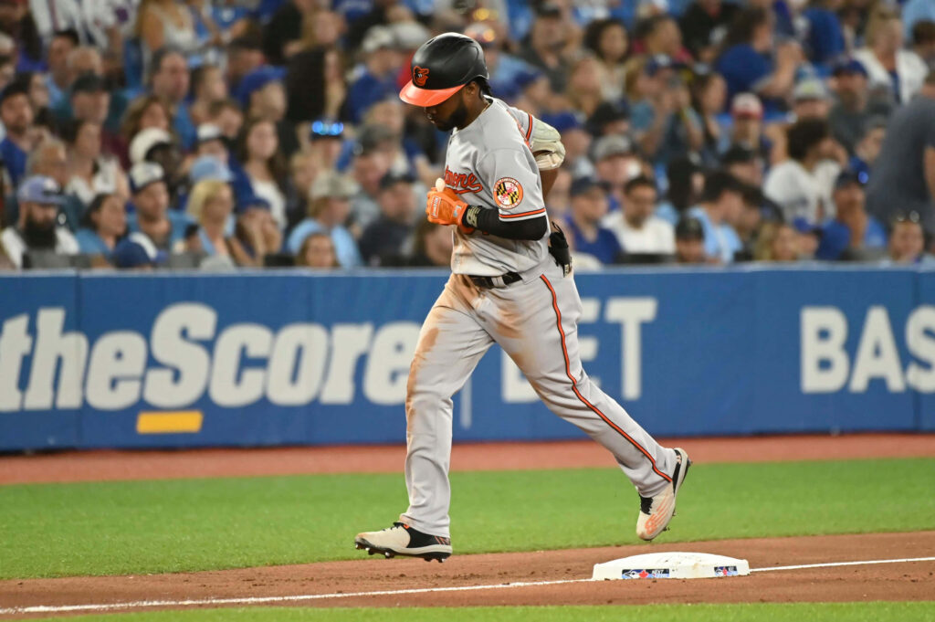 Cedric Mullins Orioles in action on baseball field vibrant stadium crowd natural lighting wallpaper