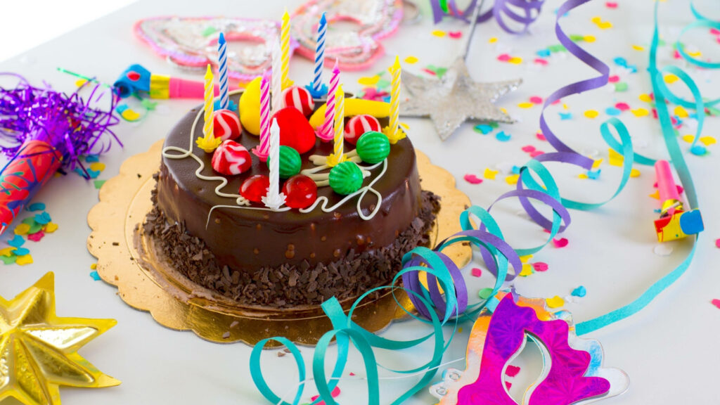 Party Fun on a Chocolate Birthday Cake - Multicolored Design with Festive Decorations! Wallpaper