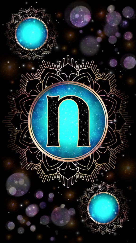 Stylized lowercase N with gold mandala frame on starry blue background glowing orbs wallpaper