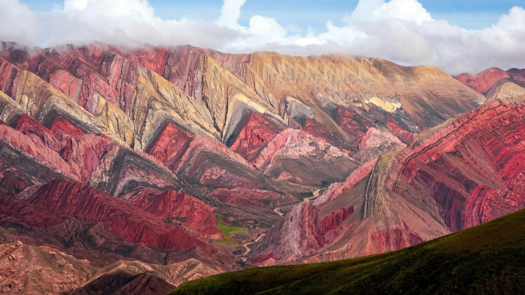 Cerro 14 Colores vibrant multicolored rock formations with red pink and yellow bands in Argentina Wallpaper