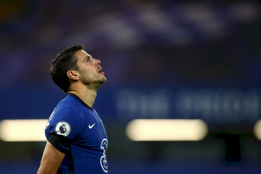 César Azpilicueta focused upward in Chelsea blue kit during intense football match closeup Wallpaper