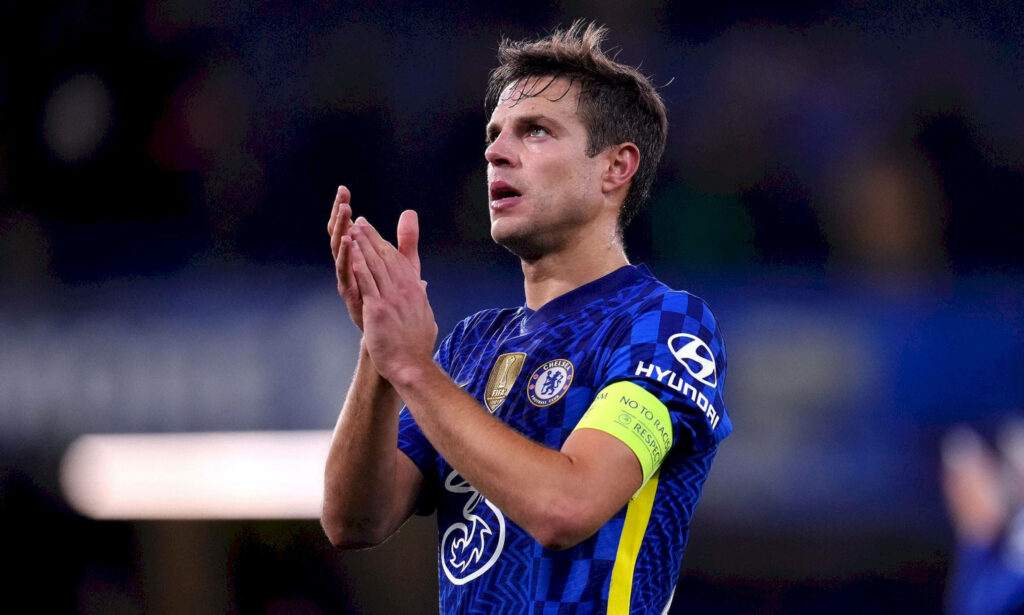 César Azpilicueta clapping in blue Chelsea jersey with captain armband blurred stadium background Wallpaper