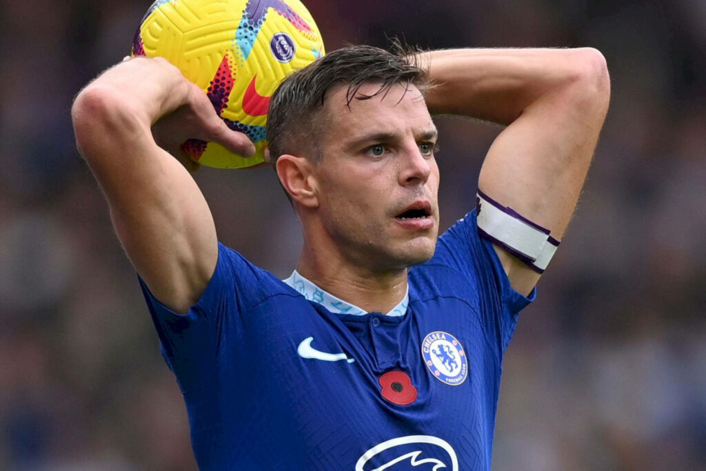 César Azpilicueta Chelsea captain preparing throw-in wearing blue kit holding yellow ball stadium Wallpaper