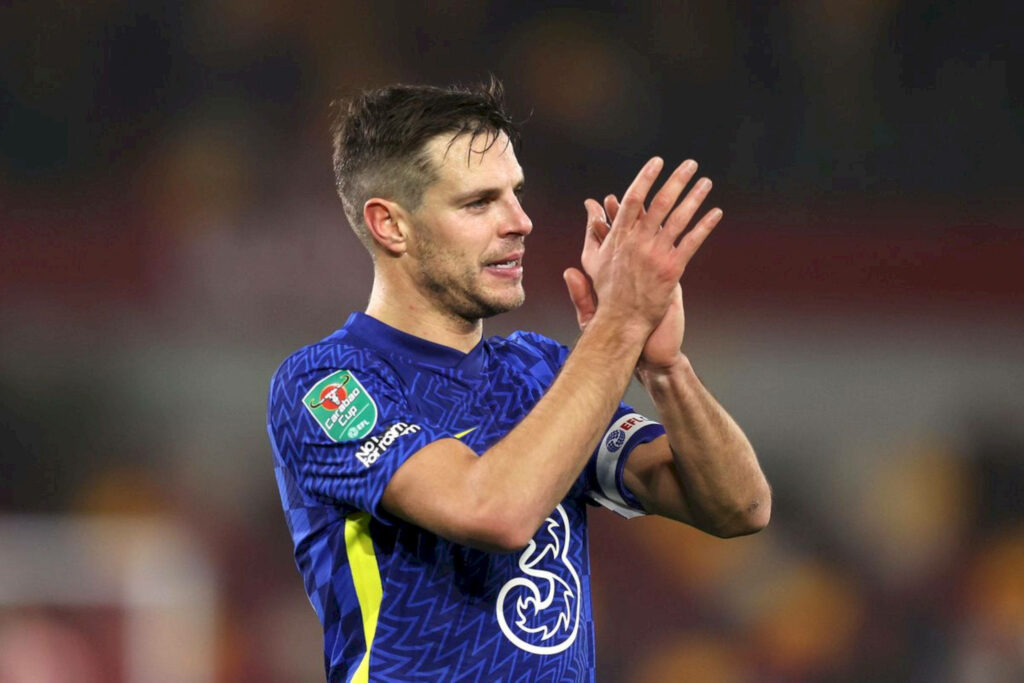 César Azpilicueta clapping in blue Chelsea kit with captain armband under stadium lights wallpaper