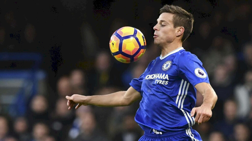 César Azpilicueta chest controls yellow purple football in blue Chelsea kit Premier League action wallpaper