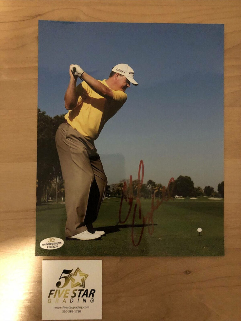 Golfer Chad Campbell mid-swing in yellow shirt autographed with Five Star Grading on golf course Wallpaper