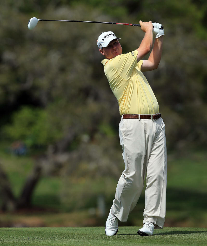 Chad Campbell mid-swing in pale yellow shirt on lush golf course showing perfect golf form Wallpaper