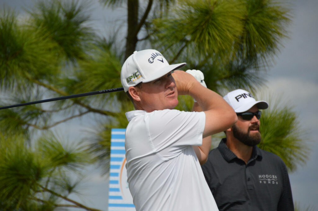 Chad Campbell golf player mid-swing on sunny course with green trees and clear blue sky wallpaper