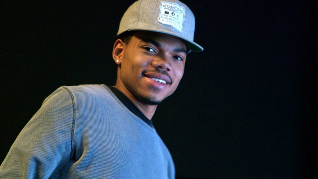Chance The Rapper in casual grey Vitamorte cap and sweater soft lighting dark background wallpaper