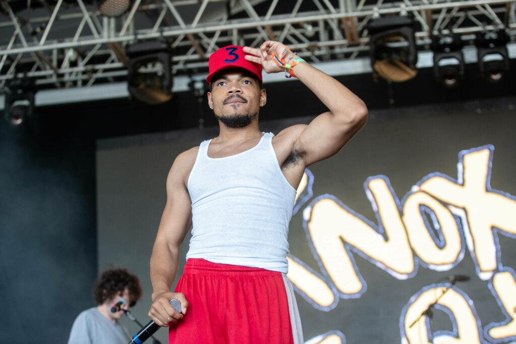 Chance The Rapper performing live in red shorts white tank top vibrant graffiti background Wallpaper