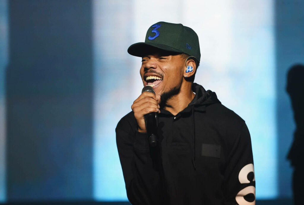 Chance The Rapper performing live wearing iconic 3 cap vibrant smile dynamic stage presence wallpaper