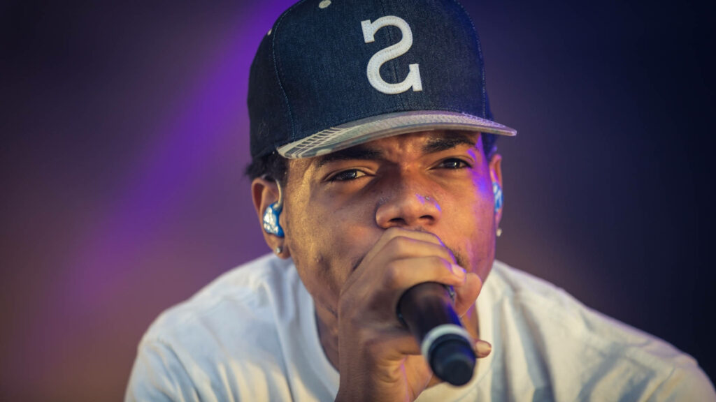 Chance The Rapper performing live with purple and blue stage lighting close-up wallpaper background