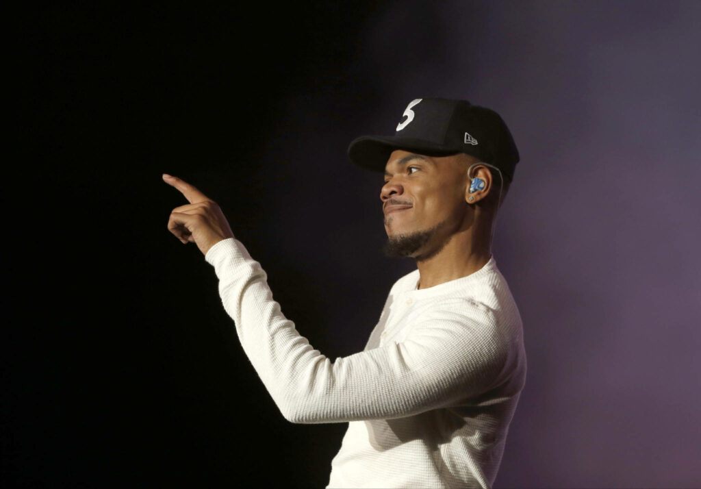 Chance The Rapper performing live wearing black hat white shirt dynamic energetic expression Wallpaper