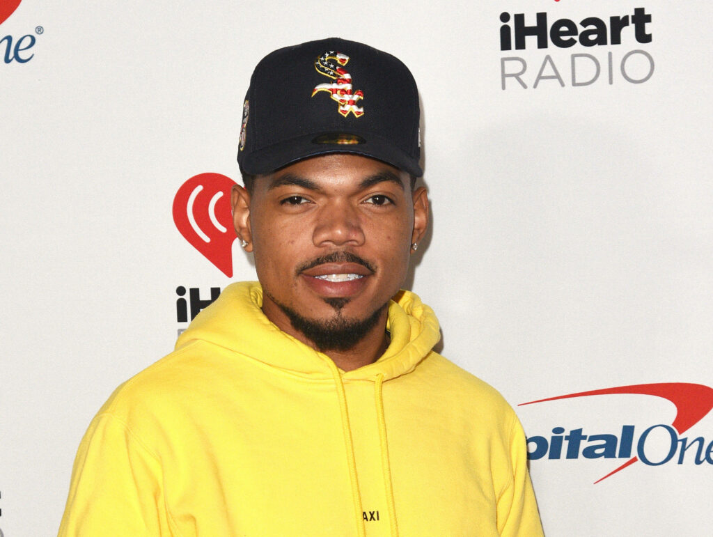 Chance The Rapper in yellow hoodie and black cap at iHeartRadio hip hop culture wallpaper background