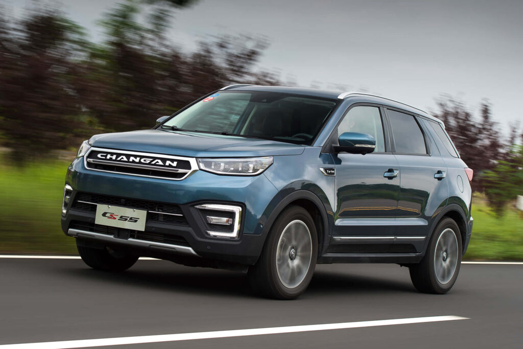 Metallic blue Changan GS55 SUV speeding on road with bold grill and sharp headlights motion blur Wallpaper