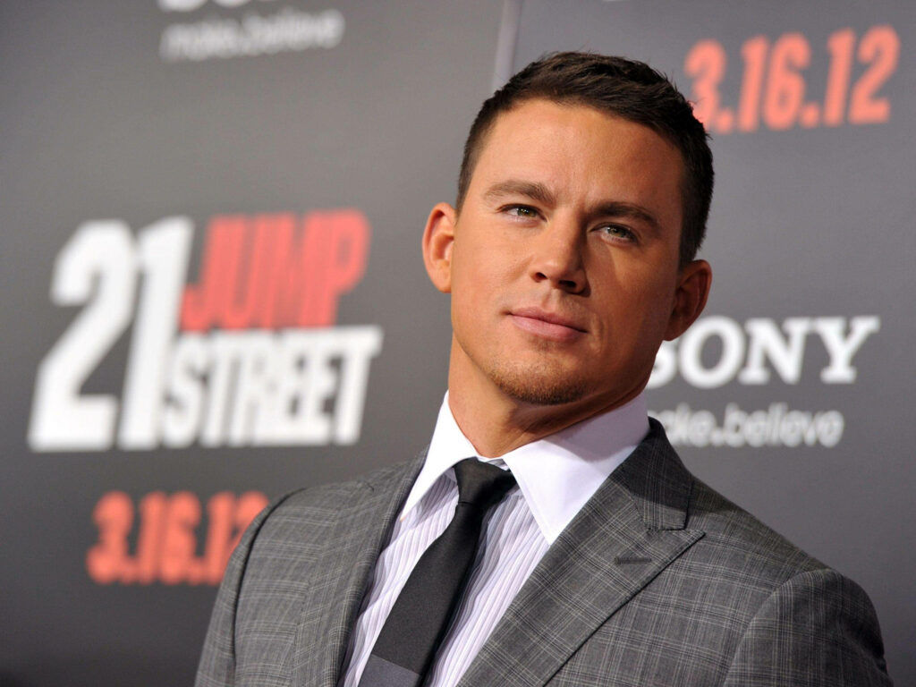 Channing Tatum in sharp grey suit confidently posing on red carpet at 21 Jump Street premiere Wallpaper