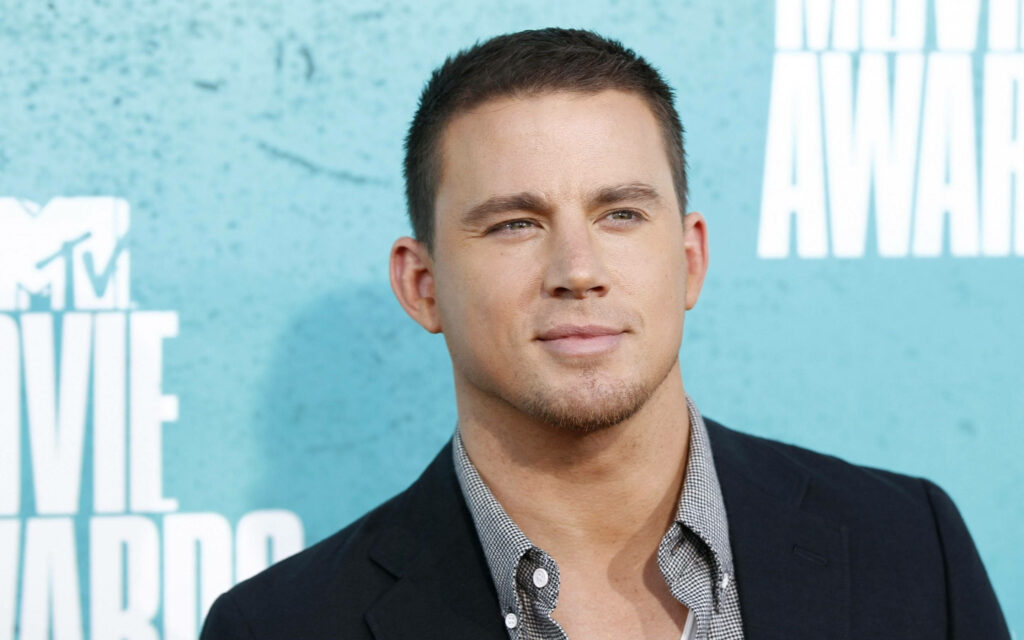 Channing Tatum in stylish suit posing confidently blue backdrop actor fan wallpaper background