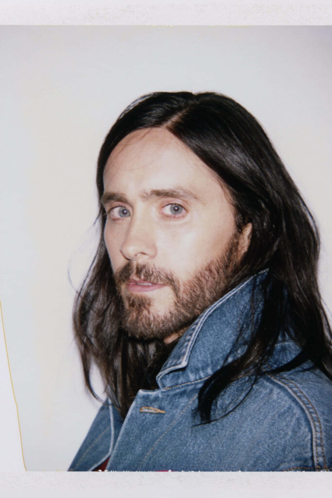 Jared Leto: Charismatic Charm in Denim Wallpaper Background
