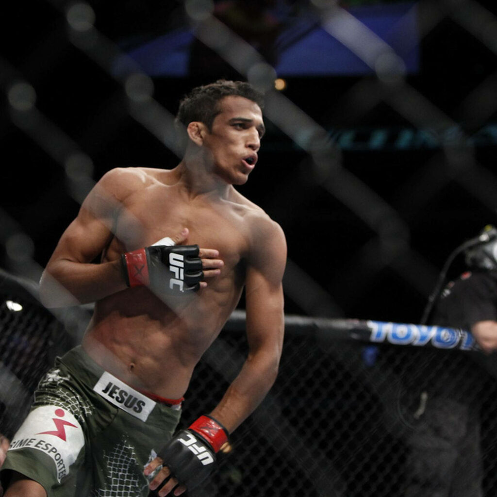 Charles Oliveira MMA fighter in octagon with hand on chest showing focus and confidence Wallpaper