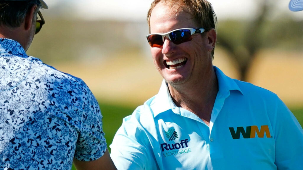 Charley Hoffman smiling in turquoise golf shirt and sunglasses celebrating on sunny golf course Wallpaper