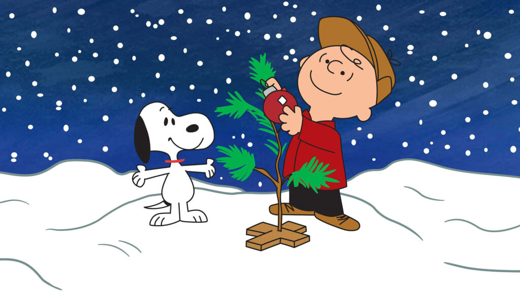 Charlie Brown & Snoopy Decorate Christmas Tree in Snowy Scene Wallpaper