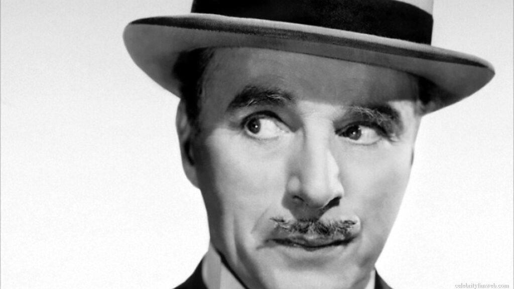 Charlie Chaplin pensive expression with signature bowler hat vintage classic film wallpaper background