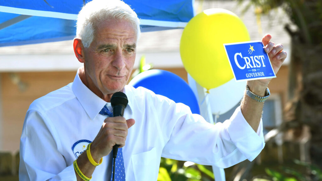 Charlie Crist speaking at vibrant outdoor governor campaign rally with colorful balloons background Wallpaper