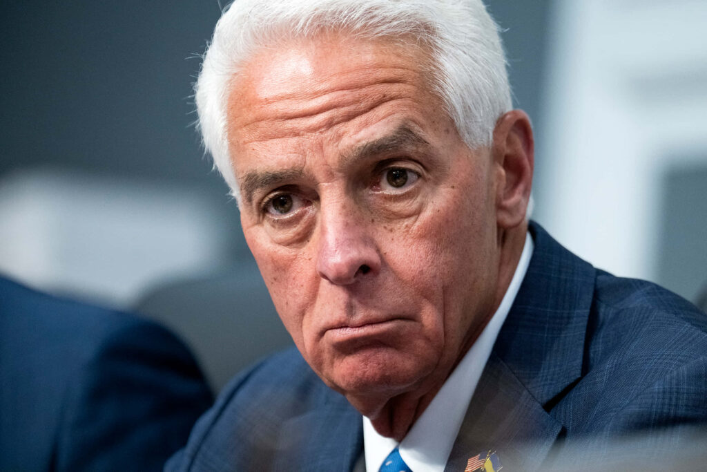 Close-up of Charlie Crist frowning in formal suit with serious intense expression neutral background Wallpaper
