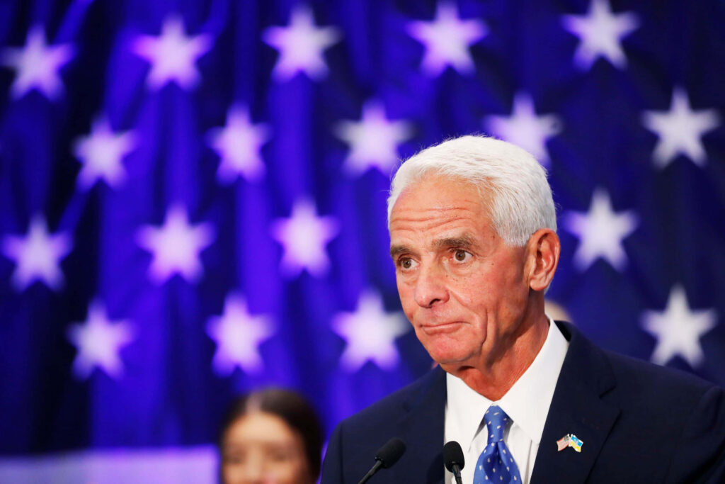 Charlie Crist serious political portrait with vibrant blue stars background and professional lighting Wallpaper