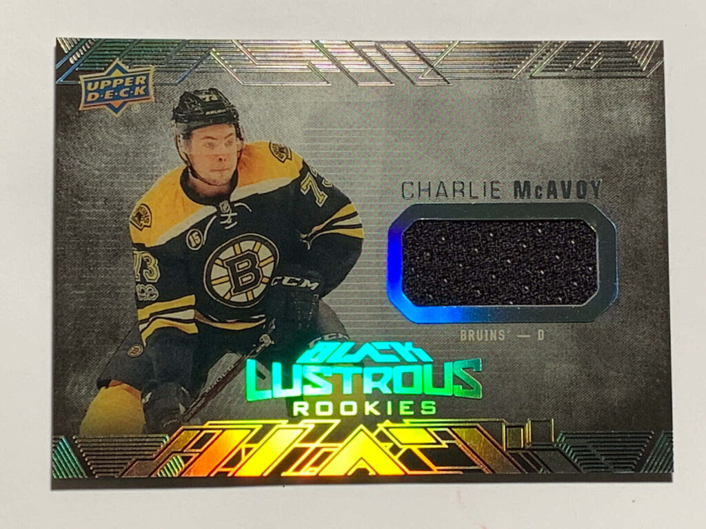 Boston Bruins rookie Charlie McAvoy metallic wallpaper with black gold holographic NHL trading card design