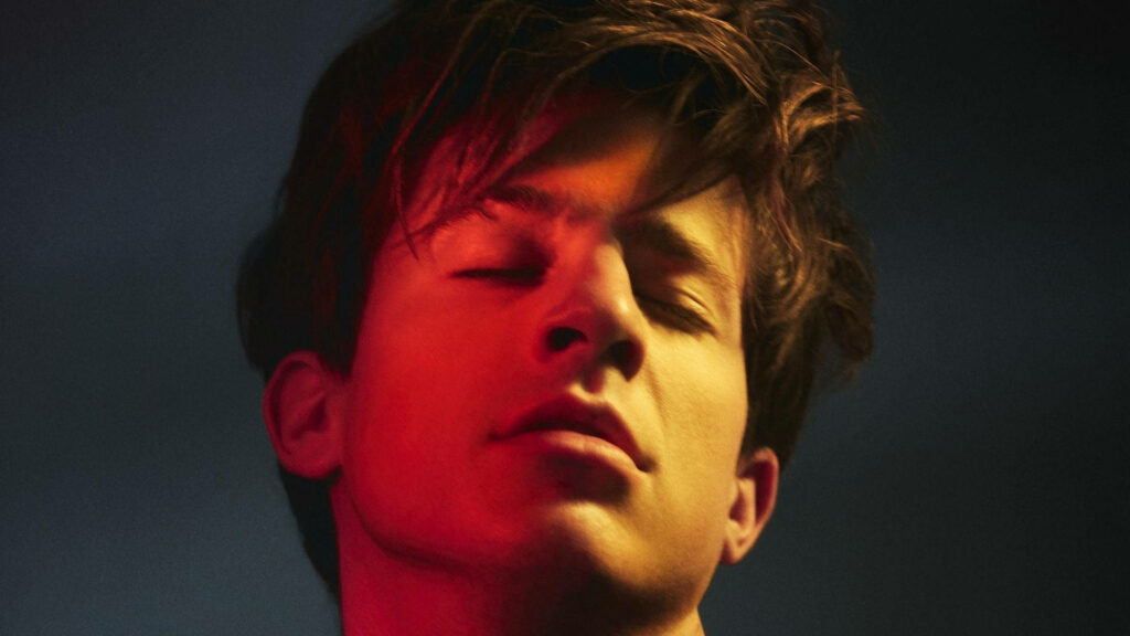 Charlie Puth close up eyes closed warm red yellow lighting emotional introspective wallpaper background