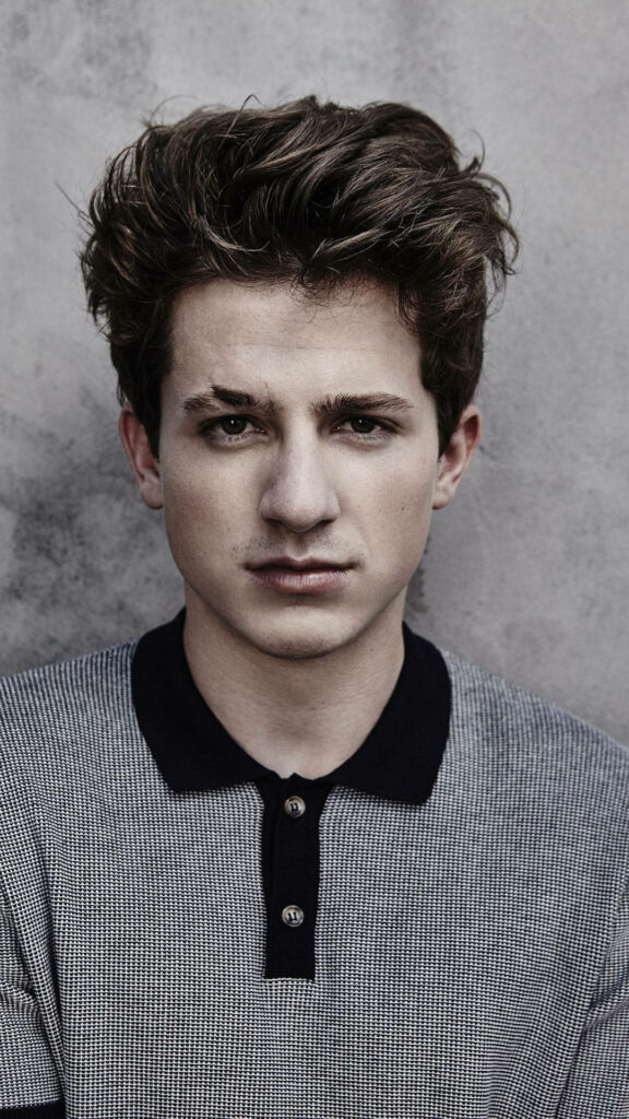 Charlie Puth intense serious look portrait with natural light and textured stylish wallpaper background