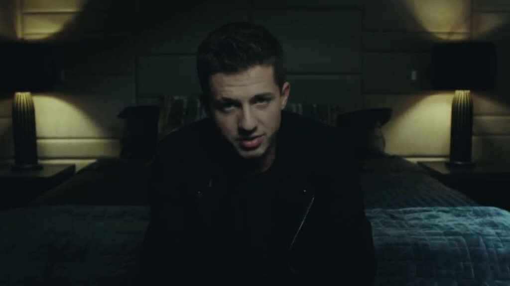 Charlie Puth in dimly lit room with soft lighting moody atmosphere intimate wallpaper background