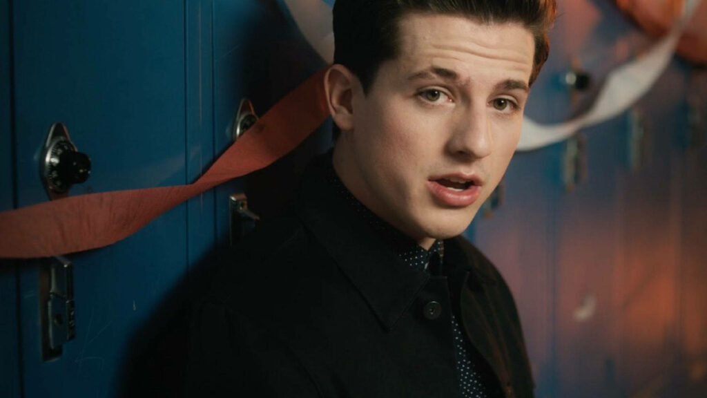 Charlie Puth in locker room with blue lockers and festive streamers background wallpaper