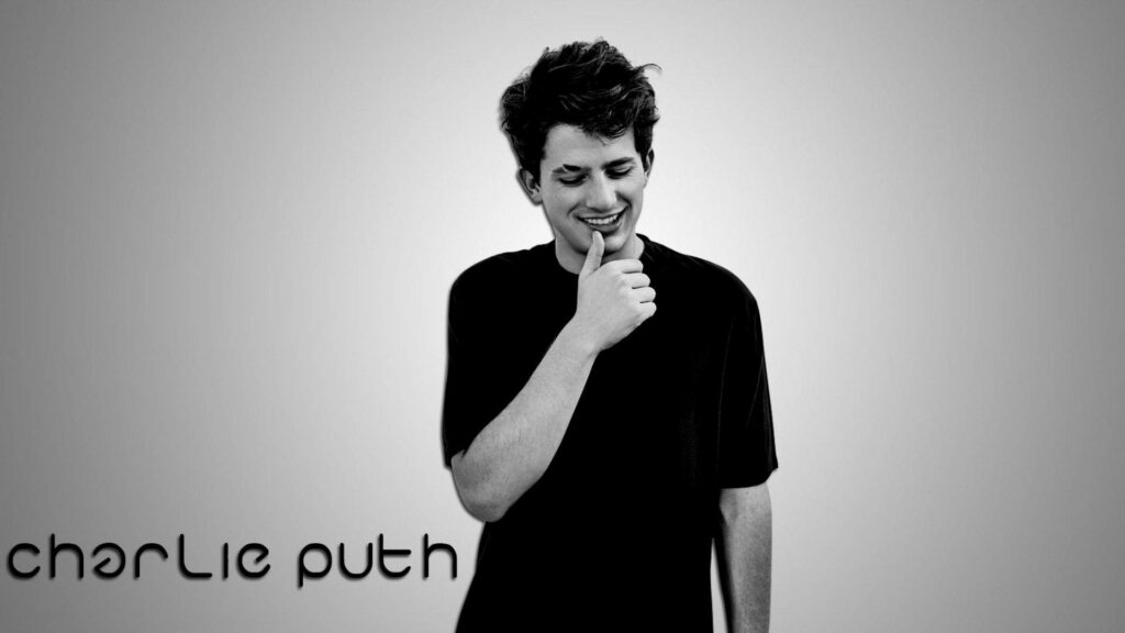 Charlie Puth smiling gently against minimalist grey background relaxing uplifting wallpaper image