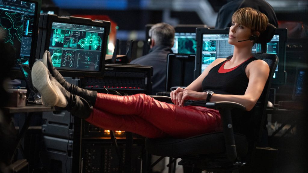 Charlize Theron as hacker Cipher in red leather pants in Fast and Furious high-tech control room wallpaper