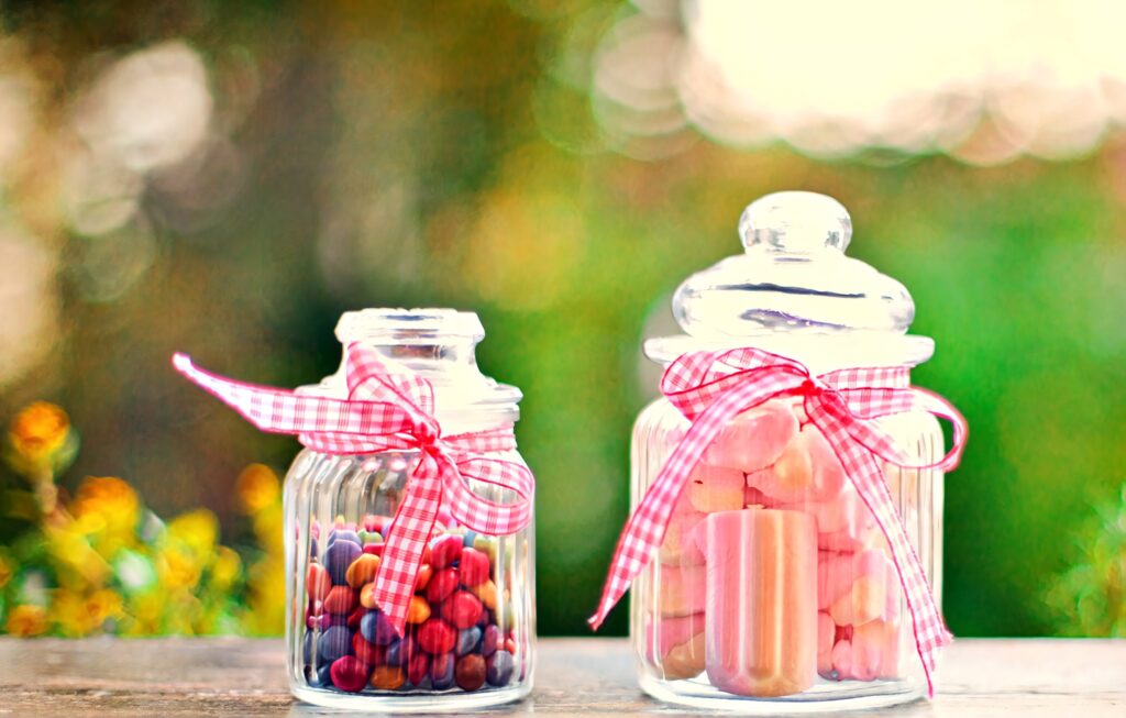 3D wallpaper with jars of marshmallows berries red gingham ribbons soft bokeh green background